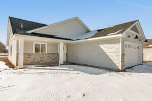 Front view of single story home in the snow
