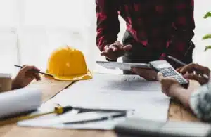 Contractor looking at calculator