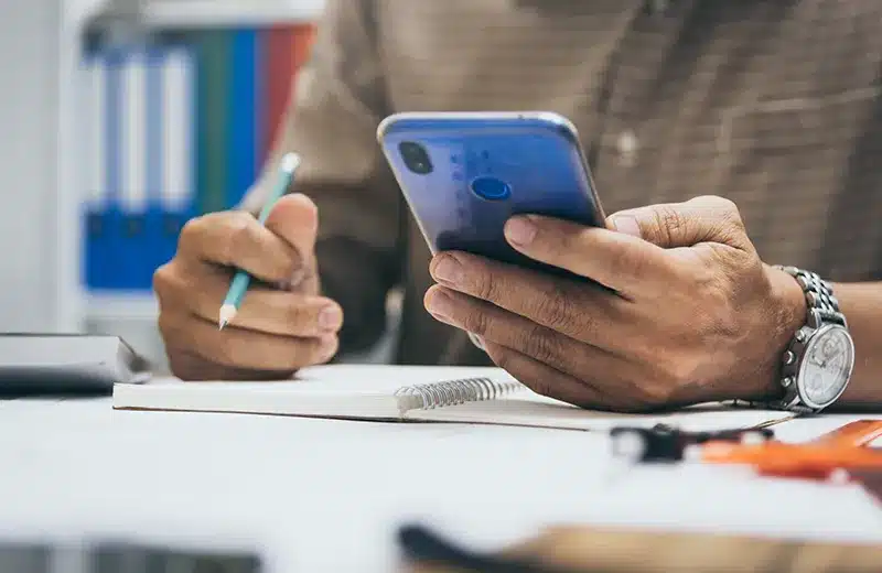 Customer looking at phone at table